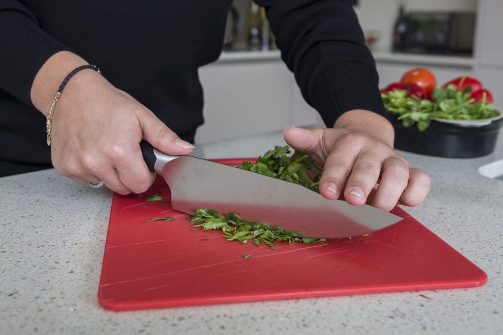 person cutting parsley