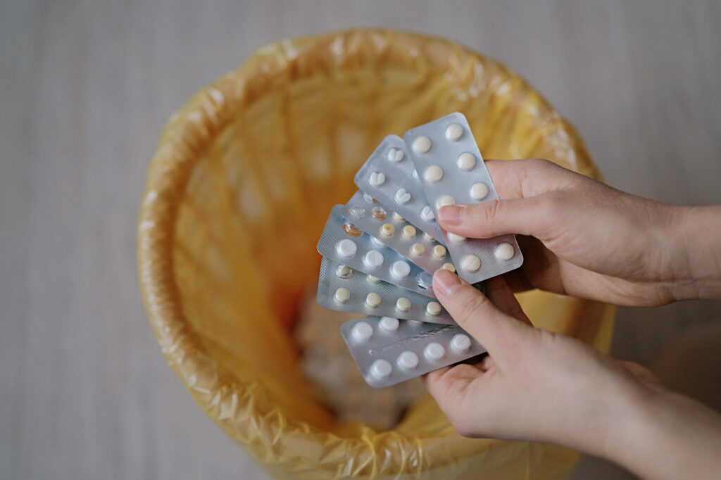A,Person,Holds,Several,Packs,Of,Pills,Over,A,Yellow